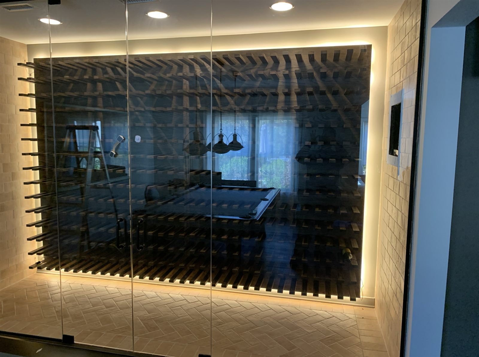 Finished glass-walled wine cellar with timber racking installed by Innovative Mechanical in a North Metro Atlanta home